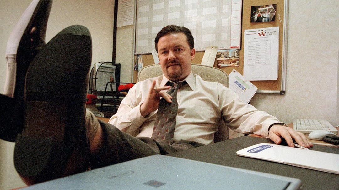 Ricky Gervais with his feet up on the desk in the Office (UK)