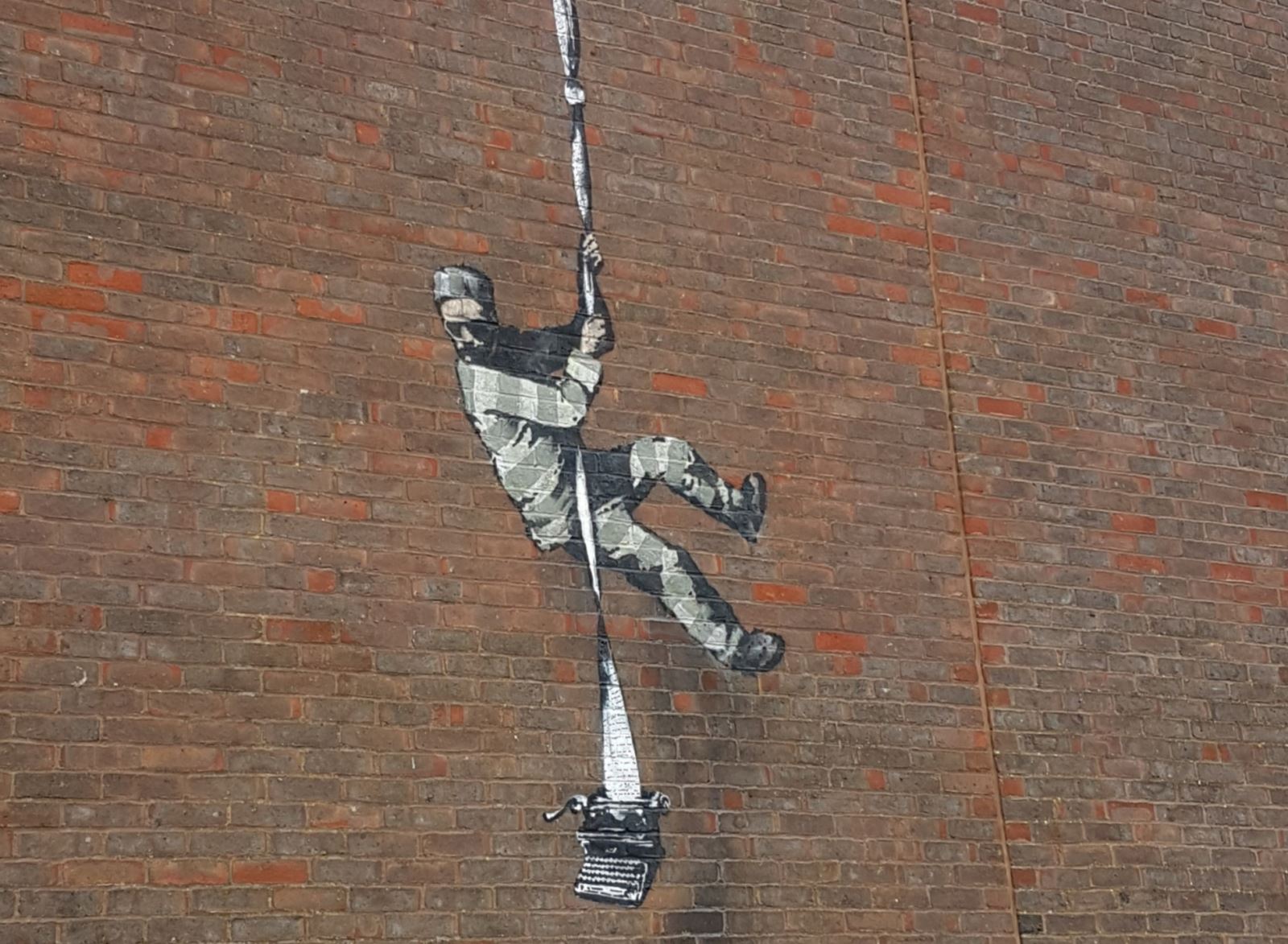 Banksy at Reading Gaol - prisoner escaping with a typewriter