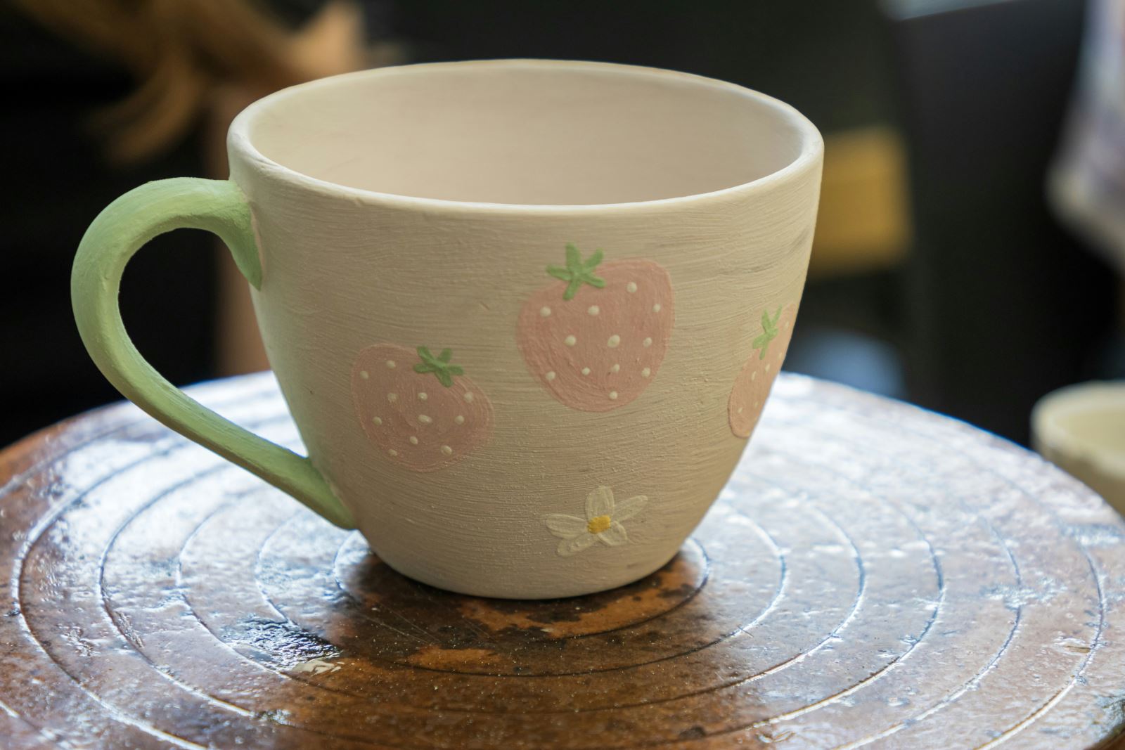 Pottery painted mug with strawberries on it